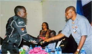 Sir Tony Okocha (right) in a handshake with the Kirikata Master, Oba Omega.