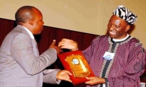 Director of Security Services, Akwa Ibom State, Mr Tamo Minti (left), receiving an award from the President, Nigerian Institute for Industrial Security (Niis), Alhaji Isa Salami, at the 6th annual conference of the institute in Uyo, yesterday. Photo: NAN