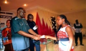 Senator representing Rivers South East Senatorial District, Senator Magnus Abe (left) present a cheque of fifty thousand naira N50,000.00 to Miss Patience Jaja (right) during the Anual Presentation of Finance Support to Law Students going for Law School from the District last Monday in Port Harcourt. Photo: Chris Monyanaga.