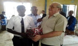 An expartriate teacher of |Comprehensive Secondary School, Borikiri, Port Harcourt, Mr K. D Smith (right), presenting a plaque to the best Mathematics student in the senior category,during a Maths school quiz competition organised by Old Boys Association of the school, recently. 