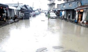 Flooded Alagba Street in Orile Iganmu community in Lagos, last Thursday. Photo: NAN