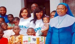   Multichoice Nigeria Customer Service Officer, Miss Nnenna Ibekwe (4th right), Branch Manager, Mrs Vivian Odenigbo (3rd right) and representative of Daughters of Divine Love (Ddl) Charity Home in Enugu, Rev. Sis. Obi-Udu Margaret-Mary (right) with inmates of the Home, during a donation by Multichoice, Enugu to mark its 2013 Customers Week in Enugu, recently. Photo: NAN