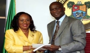 Chairman, Tribunal of Inquiry into Collapsed Buildings in Lagos, Mrs Abimbola Ajayi (left), presenting the report of the tribunal to Governor Babatunde Fashola of Lagos State last Monday. Photo: NAN