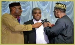 Former District Governor of Rotary Club of Port Harcourt, District 9140, Mr G. T. G. Toby (right), decorating one of the highest donors to Rotary Foundation, during the Rotary International night celebration at Rotary Centre, Port Harcourt, last Monday. With them is the President, Rtn Chidi Ikeji (left).