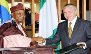 Vice President Namadi Sambo (left), exchanging a signed Bilateral Agreement with the Brazilian Vice President, Mr Michel Temer, at the Itamaraty Palace in Brazil last Tuesday.