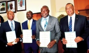  Deputy Managing Director, UBA, Mr Kennedy Uzoka, Director, First Bank, Abdullahi Ibrahim, Director-General, Bureau of Public Enterprises, Mr Benjamin Dikki and Executive Director, FCMB, Adam Nuru, displaying signed escrow agreement  signed in Abuja,  last Tuesday. Photo: NAN. 