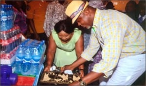 Rivers State Commissioner for Commerce and Industry, Barrister Chuma Chienye, inspecting an item at the Port Harcourt Christmas Discount Market in Port Harcourt last Thursday. Photo: Chris Monyanaga
