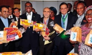 Secretary-General, D-8 Organisation for Economic Cooperation, Mr Seyed Mousavi (left), Minister of Agriculture and Rural Development, Dr Akinwumi Adesina (3rd left), and other delegates, displaying cassava bread, at the 4th D-8 Agricultural Ministerial Meeting on Food Security in Abuja last Friday. Photo: NAN