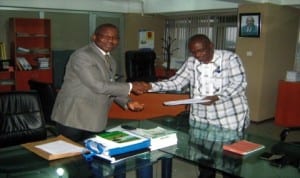 Rivers State Head of Service, Barr Samuel LongJohn (right), receiving a report on the verification of the status of Unique Cooperative Society (loan facilitators) from the Solicitor General and Permanent Secretary, Ministry of Justice, Barr Rufus Godwins in Port Harcourt, last Friday.