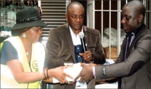 Rivers State Permanent Secretary, Ministry of Special Duties, Dame Mina Benebo (left), presenting some fire safety documents to Chairman, Mile One Market Traders Association, Deacon Keneth Eze (right), during a public sensitisation programme on fire safety and prevention to markets and parks organised by the Ministry in Port Harcourt last Wednesday. With them is Commissioner for Special Duties, Barrister Dickson Omunakwe.