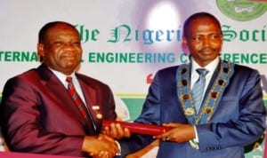 Minister of Power, Prof. Chinedu Nebo (left), receiving special merit award and fellowship conferment from the President, Nigerian Society of Engineers, Mr Mustafa Shehu, at the opening of the 2013 International Engineering Conference, Exhibition and Annual General Meeting in Abuja, yesterday. Photo: NAN