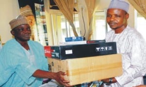 Chairman, Nuj, Bauchi State Council, Comrade Dahiru Mohammed (right), presenting a set of computer to the  State Commissioner for Information, Alhaji Mohammed Dhamina, in Bauchi,   recently. Photo: NAN