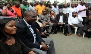 Rivers State legislators sitting outside the House of Assembly Complex.