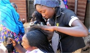 Women plaiting hair in a last minute preparation for Christmas celebration at Kasuwan Waya in Bauchi, yesterday.