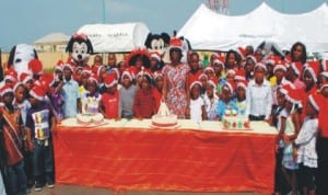 Wife of Delta State Governor, Mrs Roli Uduaghan with children at the Christmas party for children in the State in Asaba, last Monday.