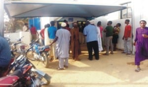 People withdrawing money from Automated Teller Machines at a bank as workers resume from New Year holiday in Suleja, Niger State, yesterday. Photo: NAN