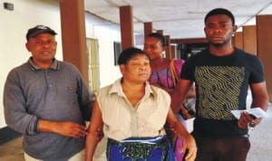 Mr Augustine Umhenin (left), helping his wife out of the University of Abuja Teaching Hospital as doctors begin warning strike in Abuja, recently.With them is the son.