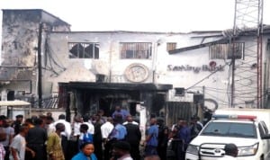 Sympathisers at a commercial bank last Wednesday affected by a fire incident which razed several shops, offices, vehicles and equipment at Olodi Apapa in Lagos last Tuesday. Photo: NAN
