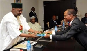 Vice President Namadi Sambo (left), receiving a report from the Director-General, Debt Management Office, Dr Abraham Nwankwo, during Debt Management Meeting at the Presidential Villa, Abuja, last Friday.