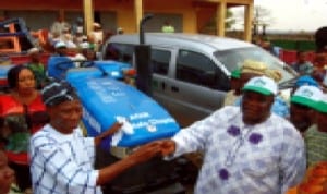 Representative of Minister of State for FCT, Alhaji Olajire Obisesan (left), presenting keys to tractors and a bus to chairman, All Farmers Association of Nigeria, Mr Olumide Ayinla, at the presentation of farming tools to farmers by the Minister, Oloye Olajumoke Akinjide in Ibadan, recently.