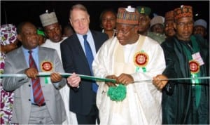 President Goodluck Jonathan (2nd right) cutting the tape to launch the Operation Light-up Rural Nigeria (OLRN) Project at Durumi community in FCT, Abuja last Monday. With him are (L-R): Minister of Power, Prof Chinedu Nebo, Country President, Schnieider Electric Nigeria, Mr Marcel Hochet and FCT Minister, Sen Bala Mohammed.
