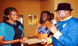 L-R: Beneficiary, Mrs Susan Jideofor, head, Small Scale Enterprises, National Directorate of Employment (NDE) Enugu, Mrs Nneka Onyeji and NDE State Coordinator, Mr Eke Iroegbu, at the NDE Micro Credit disbursement in Enugu, yesterday. Photo: NAN