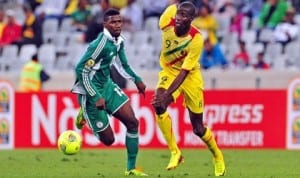 Super Eagles Shehu (left) in contest with Mozambican opponent in Group A encounter at the 2014 CHAN in South Africa