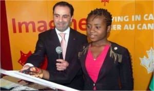 Canadian Deputy High Commissioner to Nigeria, Marcello Difanco (left) and a Student, Miss Bianca Agwunobi,cutting the tape to declare open Canadian  Education Fair in Lagos, last Friday 