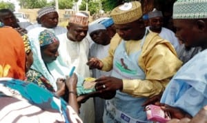 Chairman, Birniwa  Local Council, Alhaji  Ali Diginsa, administering oral polio vaccine on a child in Birniwa, Jigawa State last  Monday.