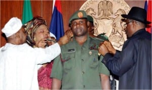 President Goodluck Jonathan (right), decorating the new Chief of Army Staff, Lt.- Gen. Kenneth   Minimah with his new rank  in Abuja last Wednesday. He was assisted by Vice President Namadi Sambo and Mrs Minimah, at the Presidential Villa in Abuja.