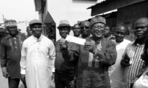 Former National Deputy Chairman of Peoples Democratic Party (PDP), Dr Sam Sam Jaja (middle), displaying his APC membership registration card, shortly after registration in Opobo Town, last Friday. With him are member, House of Representatives, Hon Dakuku Peterside (left) and Exective Chairman, Opobo/Nkoro LGA, Hon Maclean Uranta (right).