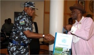 Rivers State Governor, Rt Hon Chibuike Amaechi (right) presenting a souvenir to the new Rivers State Police Commissioner, Mr Tunde Ogunsakin, during a courtesy visit to Government House, Port Harcourt, yesterday