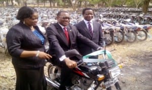 L-R: Permanent Secretary, Mrs Ibokun Odusote, Minister of Agriculture and Rural Development, Dr Akinwumi Adesina and Director, Extension Services, Mr Damil Ola Eniaiyeju, at the inauguration of 800 motorcycles to revamp agricultural extension services  across the nation in Abuja, yesterday.