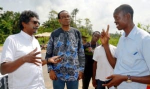 L-R: Former South African Minister of Reconstruction and Development, Mr Jay Naidoo, an environmentalist, Mr Nnimmo Bassey, (middle) and a community leader, Chief Amangi Daniel, exchanging views on the first oil well in Nigeria located at Oloibiri, in Otuabagi, Ogbia Local Government Area of Bayelsa State last Wednesday. Photo: NAN