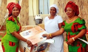 Coordinator,  Nigerian Army Officers’  Wives Association (NAOWA), 2 Brigade , Port Harcourt, Mrs Adesuwa Uzamere (left),  presenting a Starter Pack to a beneficiary, while one of the NAOWA officials watch, at the graduation of NAOWA vocational skills acquisition trainees at Bori Camp, Port Harcourt last Friday.