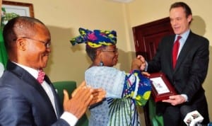 Chief Executive Officer, CITI Group, Europe, Middle East and Africa, Mr James Cowle (right), presenting the 2013 Emea Finance Best Sovereign Bon Award  for innovative financing of power infrastructure to the Minister of  Finance  and Coordinating Minister for Economy, Dr Ngozi Okonjo-Iweala, in Abuja last Friday.  With them is the Director-General, Debt Management Office,  Dr Abraham Nwankwo.