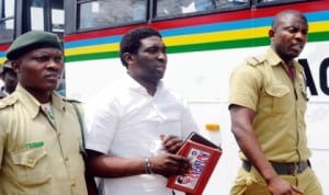 A man who stabbed his Banker wife to death in Lagos in June, 2011, Akolade Arowolo (middle), sandwitched by Prison officials after he was sentenced to death by Lagos State High Court in Ikeja, last Friday. Photo: NAN