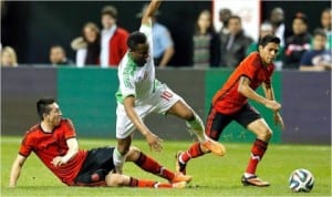 Super Eagles Mikel Obi (10) against Mexican opponents during an international friendly between Nigeria and Mexico in USA last week