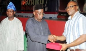 L-R: Head of Banking, CBN Enugu, Mr Osagie Agbonabori, Controller, CBN Enugu, Mr Patrick Okonkwo and representative of Zenith Bank Plc, Mr Emeka Madu, receiving award of the Most Efficient Bank, during Enugu Bankers' Committee Award Night in Enugu, recently.