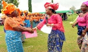  President, Ikwerre Women Forum (IWF), Hon. Victoria Nyeche (middle), in a handshake with Co-ordinator,  IWF, Mrs Grace Wori Amadinna, while other members watch, during the  inauguration ceremony of the group in Isiokpo. Rivers State, recently. Photo: NAN.