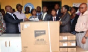 Deputy Administrator, Bloombreed High School, Port Harcourt, Mr. Animasahurl Olorunfeme (middle), presenting a printing machine and computer printer to the Princeipal of Community Boys Secondary School, Elelenwo, Mr Oko-Jaja (left), Alasomuka Violet, Director of Studies, Bloombreed High School (3rd right) in Port Harcourt, recently. Photo: Chris Monyanaga.