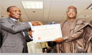 Chairman, Nigerian Electricity Regulatory Commission  (NERC), Dr Sam Amadi (left), presenting an Embedded Generation License to Governor Isa Yuguda of Bauchi State for  Yankari Power Company Limited in  Abuja, last Wednesday.