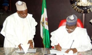 Gov. Sule Lamido of Jigawa Signing into Law the 2014 budget in Dutse last Wednesday. With him is the Commisioner for Finance, Alhaji Umar Roni.
