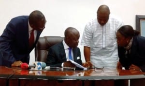 L-R: Attorney-General and Commissioner for Justice, Delta State, Mr Charles Ajuyah, Governor Emmanuel Uduaghan, Speaker, Delta State House of Assembly, Mr Victor Ochei and Clerk of the Assembly, Lyna Ochulor, at the signing of the N451billion 2014 Delta Budget into Law in Asaba last Monday. Photo: NAN
