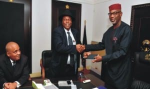 Cross River State Governor, Senator Liyel Imoke (right), receiving an Ipad made in Calabar phone and Ipad Assembling plant from the Minister of Niger Delta Affairs, Arch. Darius Ishaku (middle), during a courtesy visit, shortly after the graduation ceremony of first batch of 100 graduates from the Centre in Calabar. Photo: NAN.