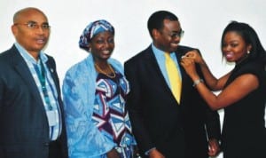 Minister of Agriculture and Rural Development, Dr Akinwumi Adesina (2nd right), being decorated with centenary Lapel Pin by the Field Executive, Centenary Lapel Pin Project, Miss Kila Abimbola in Abuja, yesterday. With them are Minister of State, Mrs Asabe Ahmed (2nd left) and Coordinator, Centenary Lapel Pin Project, Mr Chuks Chilaka. Photo: NAN