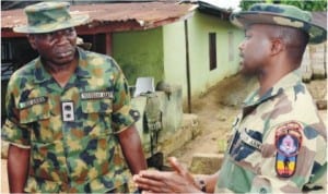 Media Coordinator, Joint Task Force, Lt.-Col. Mustapha Anka (left), with the Commander of the troops deployed to Ibaa community, Capt. M. Yahaya, after a violent clash between two cult groups, which sacked eesidents of the community in Rivers, last Wednesday.