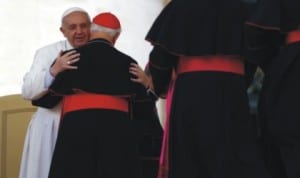 Catholic Pope Francis embraces a cardinal as he leads the general audience in Saint Peter’s square at the Vatican on Easter