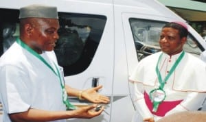 Chief Executive Officer, Peace Mass Transit (PMT), Mr Sam Onyishi (left), and the Catholic Bishop of Nsukka Diocese, Most Rev. Godfrey Onah, during the donation of 18-seater bus by PMT to Nsukka Diocese in Enugu, yesterday. Photo: NAN