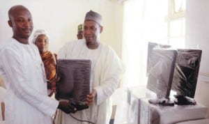 Chairman, Kaura Local Government Area, Katsina State, Alhaji Abdulhadi Abdullahi (right), presenting six sets of computers to the Chairman, Nigeria Union of Journalists (NUJ), Kaduna State Council, Mr Yusuf Idris in Kaduna last  Wednesday.